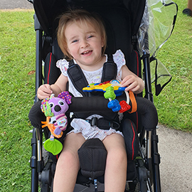 Abi-Rose in her Snappi pushchair using her grip rail