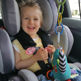 Aurora in her swivel car seat