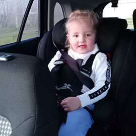 Lara in her car seat