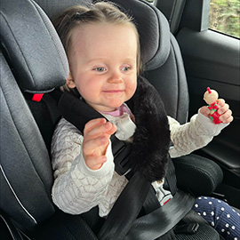 Rose in her car seat