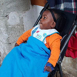 Samuel in his Snappi pushchair