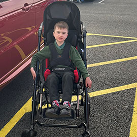 Ted in his Snappi pushchair